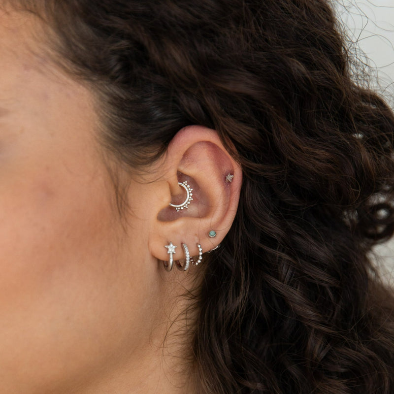 model wearing ear stack including beaded hoop daith earring in sterling silver