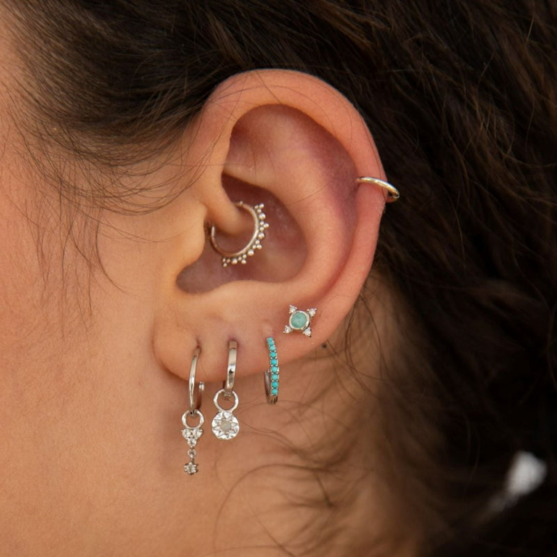 model wearing ear stack including beaded hoop earring in sterling silver