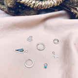 sterling silver earrings and charms displayed on fabric including the Zohreh Coin Earring Charm Sterling Silver
