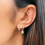 solid metals ear stack including the Zohreh Coin Charm Hoop Earrings Sterling Silver