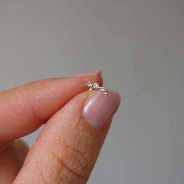 close up of diamond flat back earring in hand