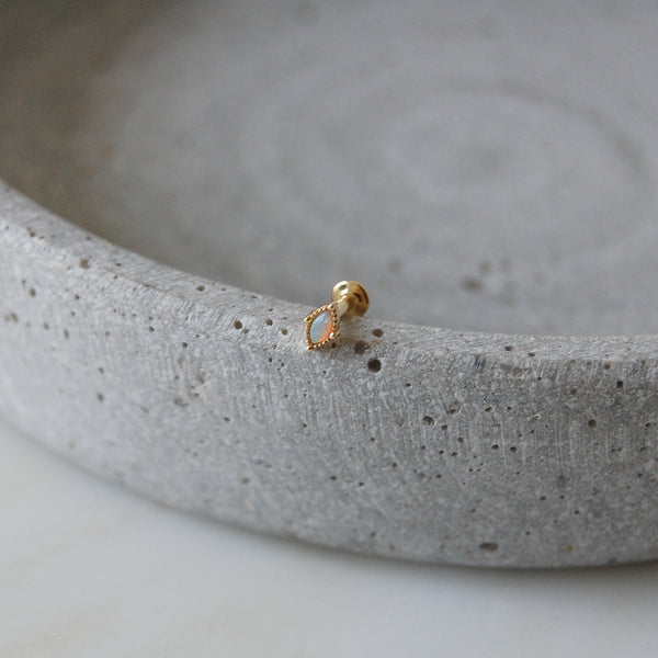 Opal flat back earring on stone dish